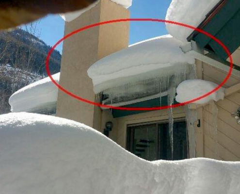 How not to take care of a home. Snow must be moved from time to time as needed. This large block of ice is crushing the wall below it. The door would not operate under it, the wall was bowed and the window one story down was being damaged as well.