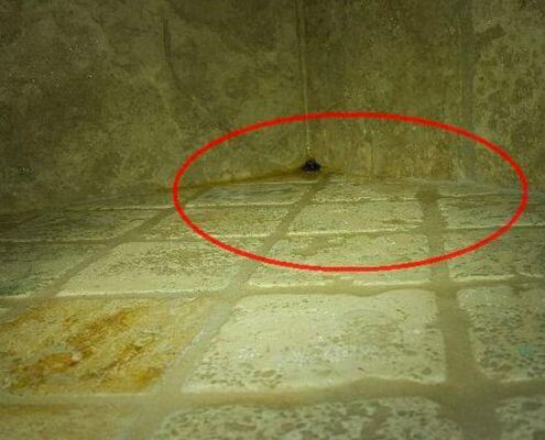 The tile in the corner of this shower is sloped towards the wall, not the drain. This can lead to water intrusion and mold.