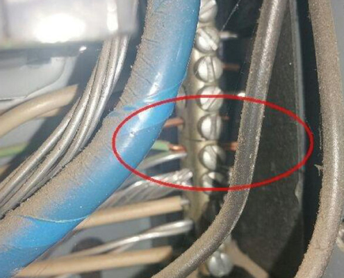 This is a photo showing two neutral wires landing on one terminal. This is the work of an amateur electrician and a dangerous situation that should be rectified. The fact that one of the wires is solid strand aluminum is even worse!